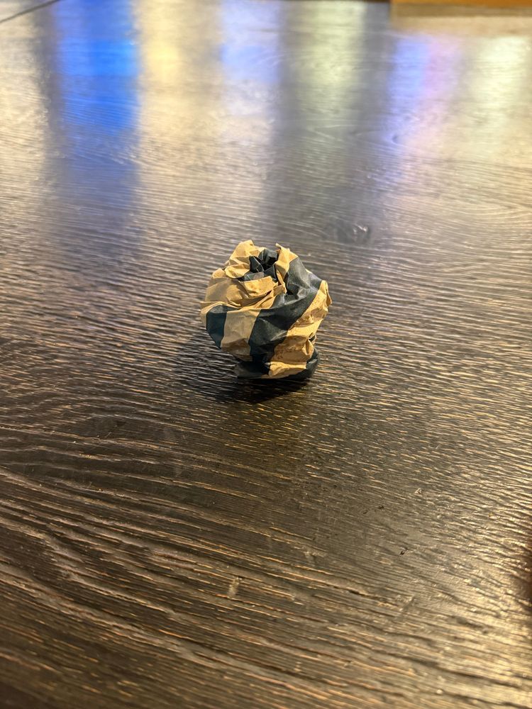 Crumbled up paper wrap on a clean table.