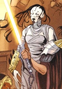 XoXaan dressed in wraps and a golden armband, she has black stringy hair and white skin with dark tattoos on her cheeks