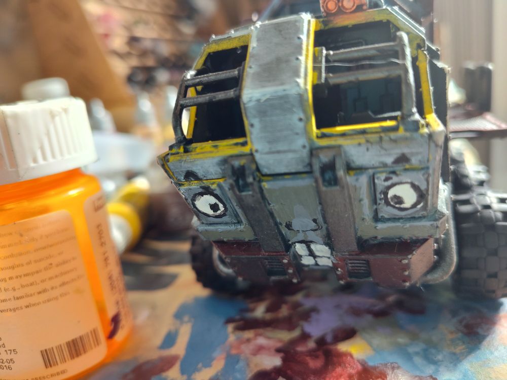 A toy truck with an angry face painted on the front