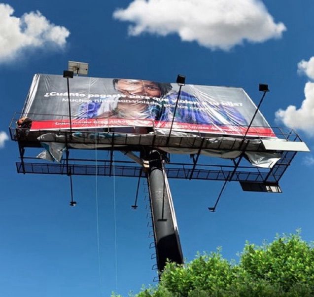 Billboard in Spanish that reads “How much did you pay to have your daughter r*ped?” one billboard reads. Another reads, 