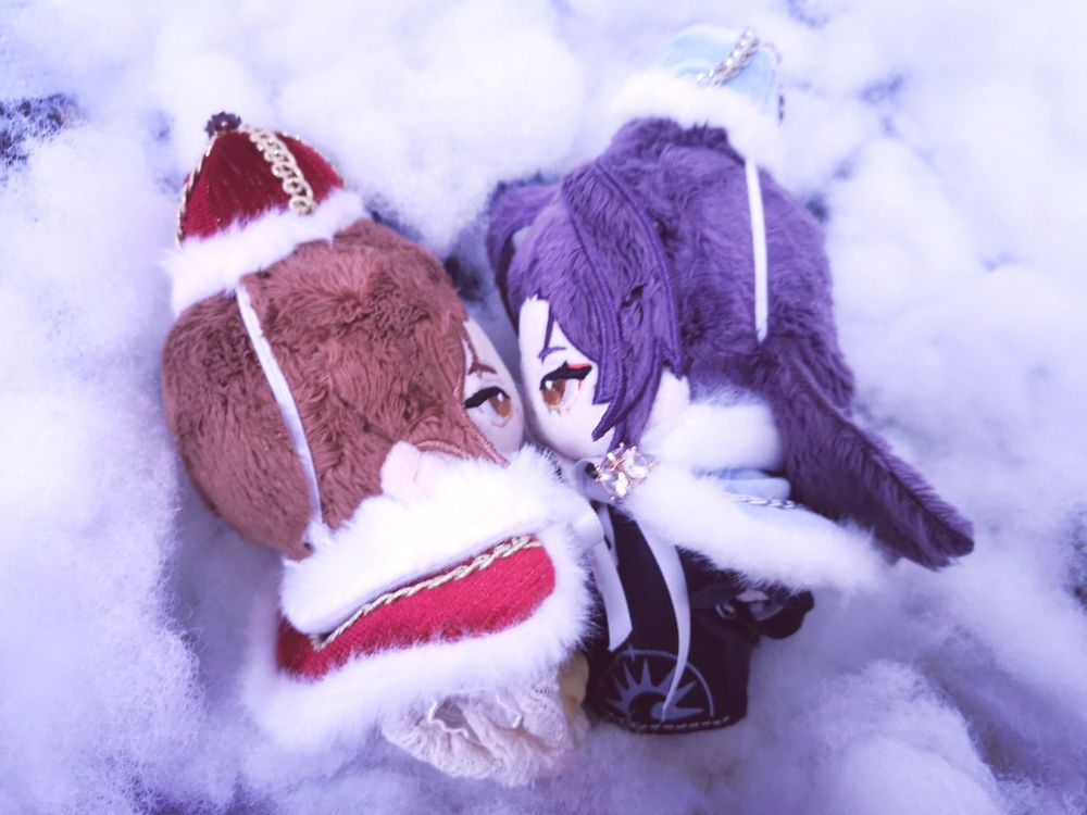 Fengqing dolls in the fluffy "snow" (poly fill), kissing. Feng Xin and Mu Qing are wearing matching capes and crowns. Feng Xin's is red with gold details and white fluffy border, Mu Qing's is light blue and silver with fluffy white border.