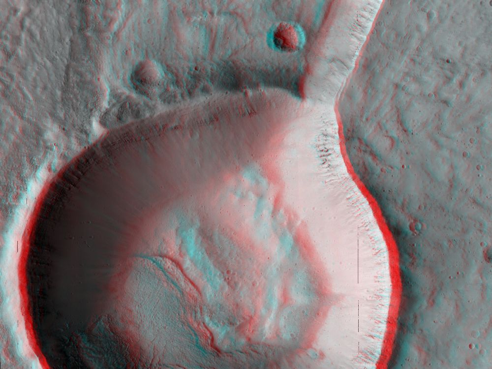 3D image shows a classic bowl-shaped crater connected to what seems to be a large, incised channel. The image almost looks like a giant spoon. The scene is less than 5 km, or 3 miles, across. (NASA/JPL-Caltech/University of Arizona)