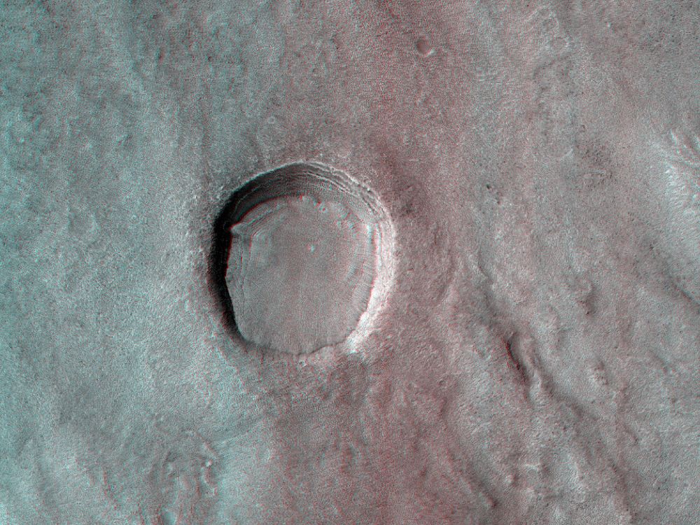 3D image shows an impact crater in Arabia Terra on Mars. The crater seems to be filled-in with material. The scene is less than 5 km, under 1 mile, across. (NASA/JPL-Caltech/University of Arizona)