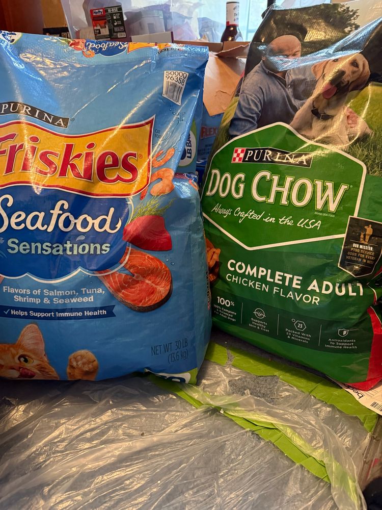 A 30lb bag of Friskies dry cat food and a 40lb bag of Dog Chow dry dog food.