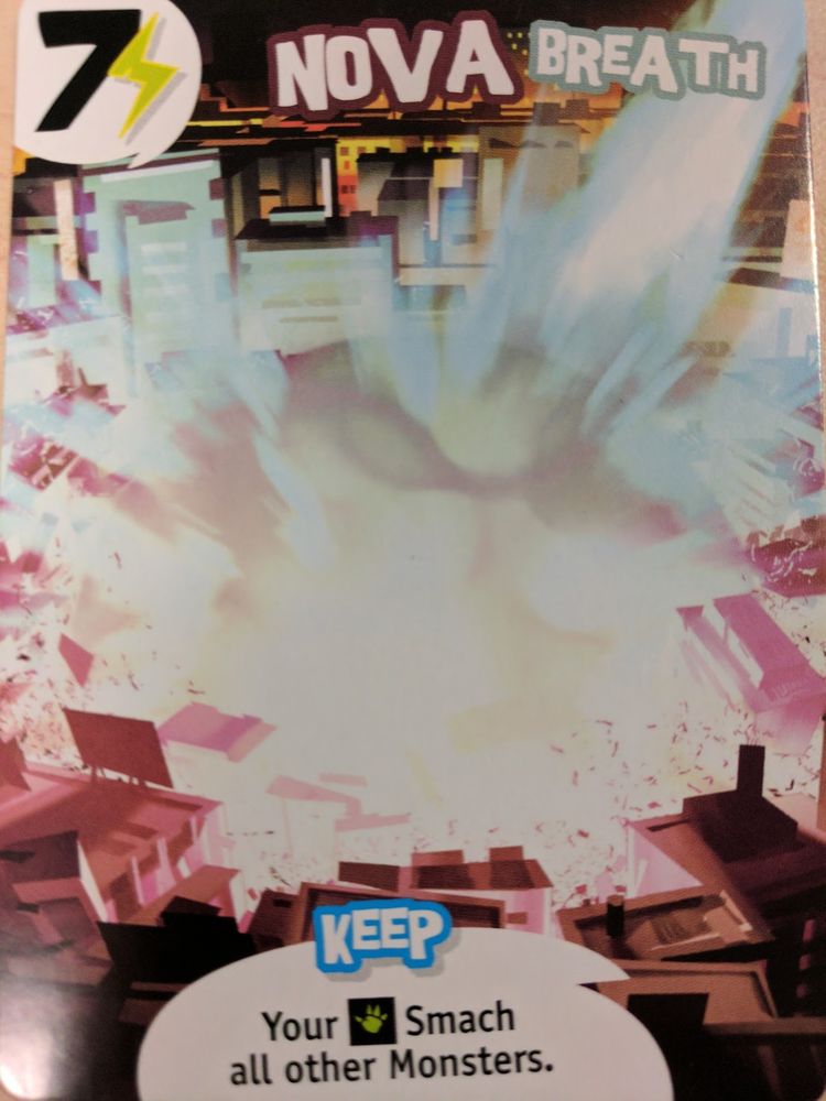 "Nova Breath" from the game King of Tokyo. The card has a typo or bad translation that reads "Your 🤚Smach [sic] all other Monsters."