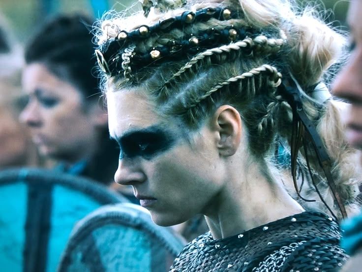 Lagertha with her shield maidens with black eye paint and braided hair. leather armor close up