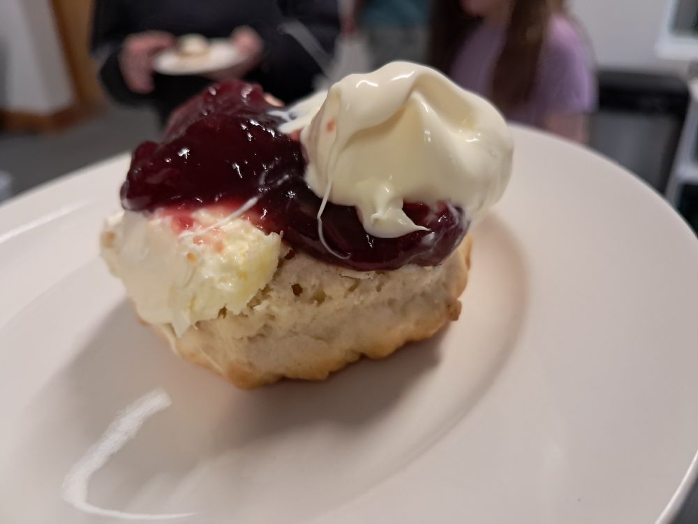 Scone with jam, then cream on one side and cream, then jam on the other