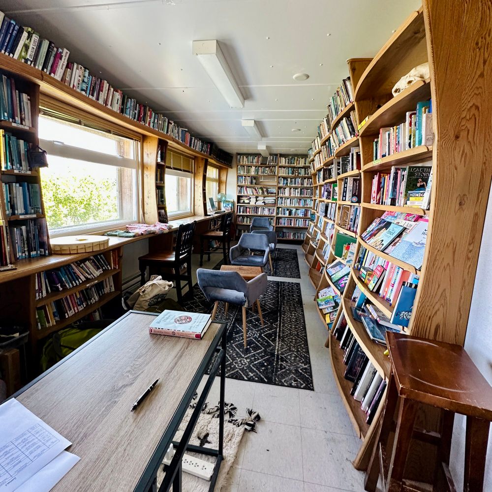 Cozy reading room with floor to ceiling bookshelves 