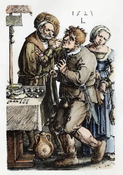 A 1523 etching of a dentist, his assistant, and his patient. The dentist is an older man with a gray handlebar moustache and close trimmed beard dressed in a coat with a fur collar and a broad-brimmed hat at a jaunty angle. Beside him is a covered table with an array of small containers and medicines in paper or bags. A pole stands nearby with a small banner and a piece of paper with an officials looking seal. The dentist is digging deep into the mouth of his patient who is dressed in a worn doublet, torn pants, and peasant shoes. The patient has his head tilted back and is looking away from the dentist and over his shoulder at the dentist's assistant behind him. She is wearing an embroidered chemise, dress, and over-dress with a purse and knife hanging from her belt. She is looking down at the patient's belt bag which she has open with one hand while the other hand plunders for valuables. The etching is by Lucas van Lyden and is dated 1523.