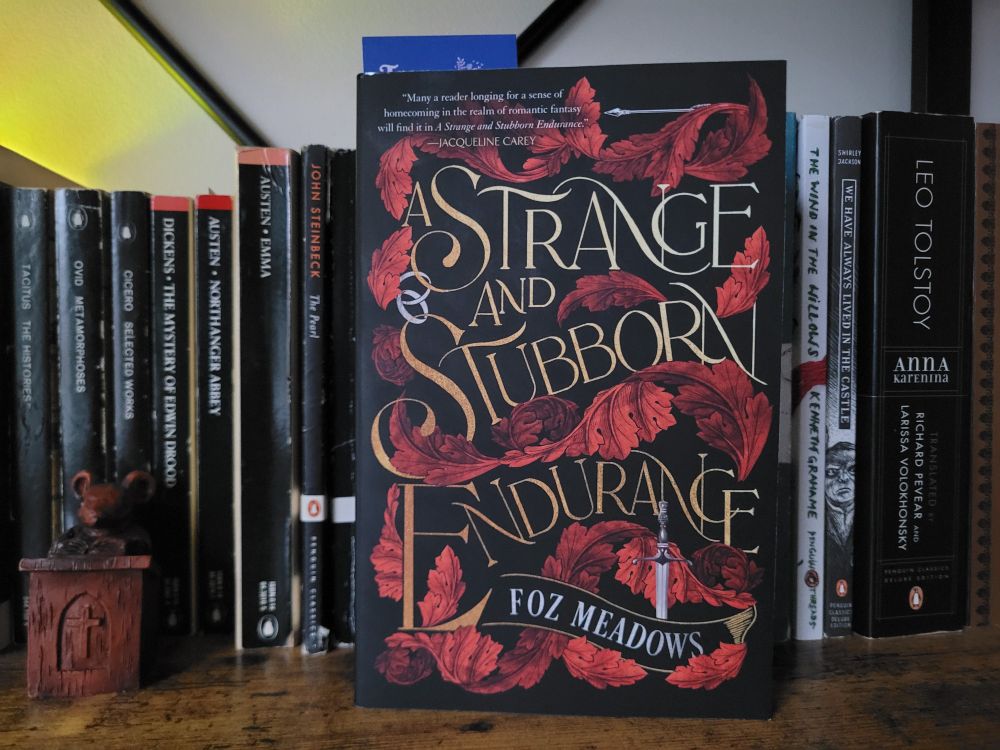 A Strange and Stubborn Endurance facing out on a bookshelf