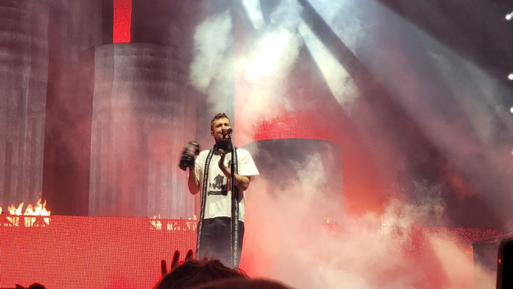 Tyler playing the tambourine with dema in the background