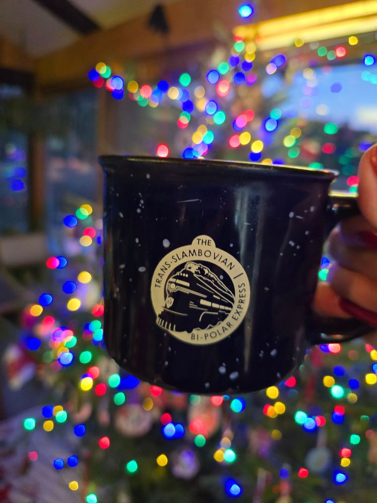 Hoisting my mug in front of my Christmas tree, about to sample today's tea selection 
