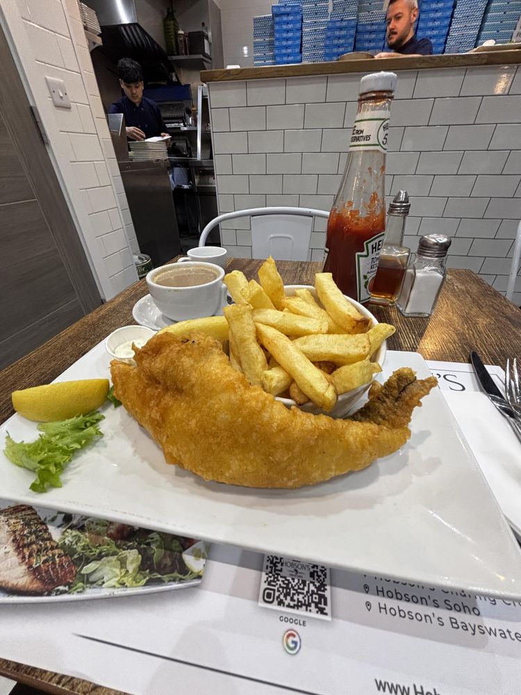 Picture of a plate of fish and chips and a cup of coffee