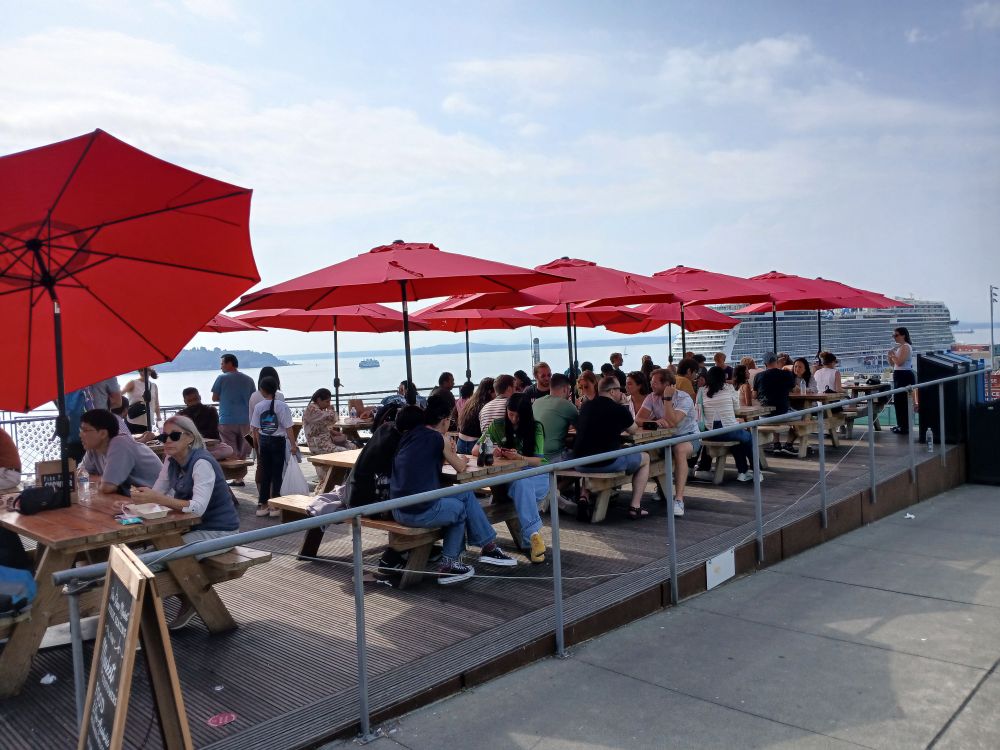 Rows of picnic tables occupied at the Pike Place Marketfront