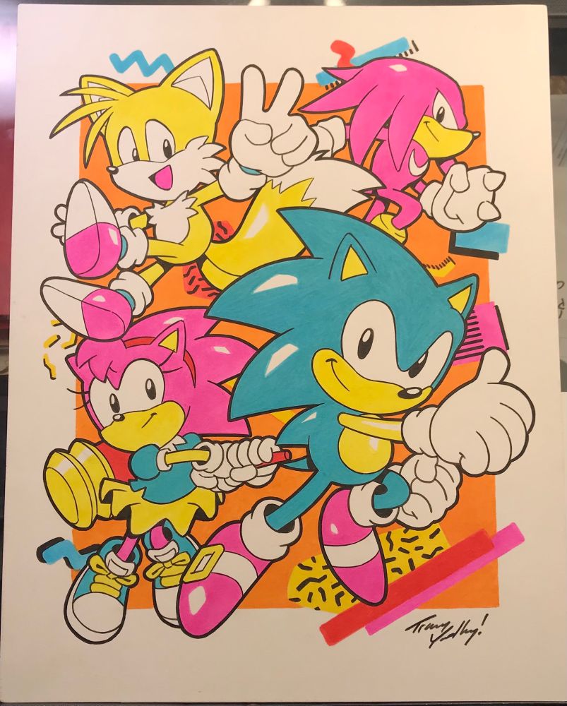Brightly colored artwork featuring Sonic, Amy, Tails and Knuckles in classic style 