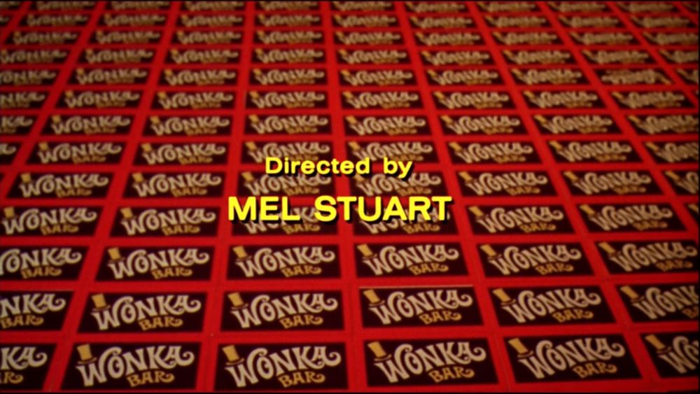 Credits from Willy Wonka & the Chocolate Factory (1971)
A lot of Wonka chocolate bars 
Text in yellow says : Directed by Mel Stuart