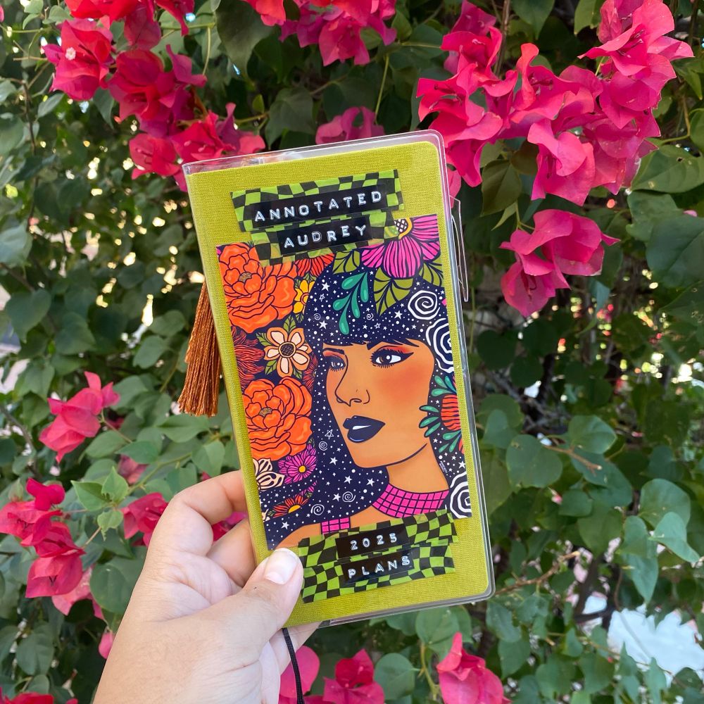Hobonichi weeks planner decorated with washi tape and an image of a Girl with flowers