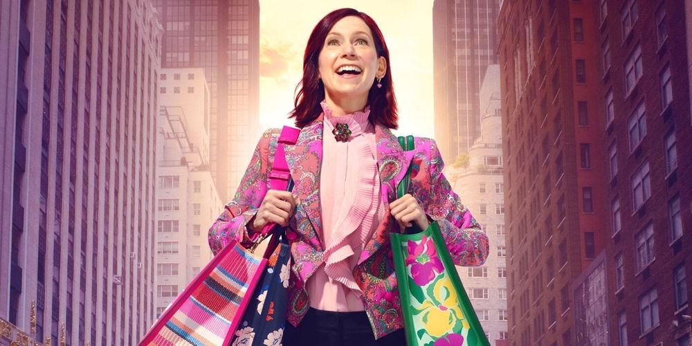 Tv show character Elsbeth Tascioni smiling brightly and carrying numerous tote bags