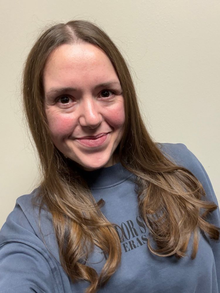 Photo of a middle aged woman with long light brown hair with a fresh cut and blowout 