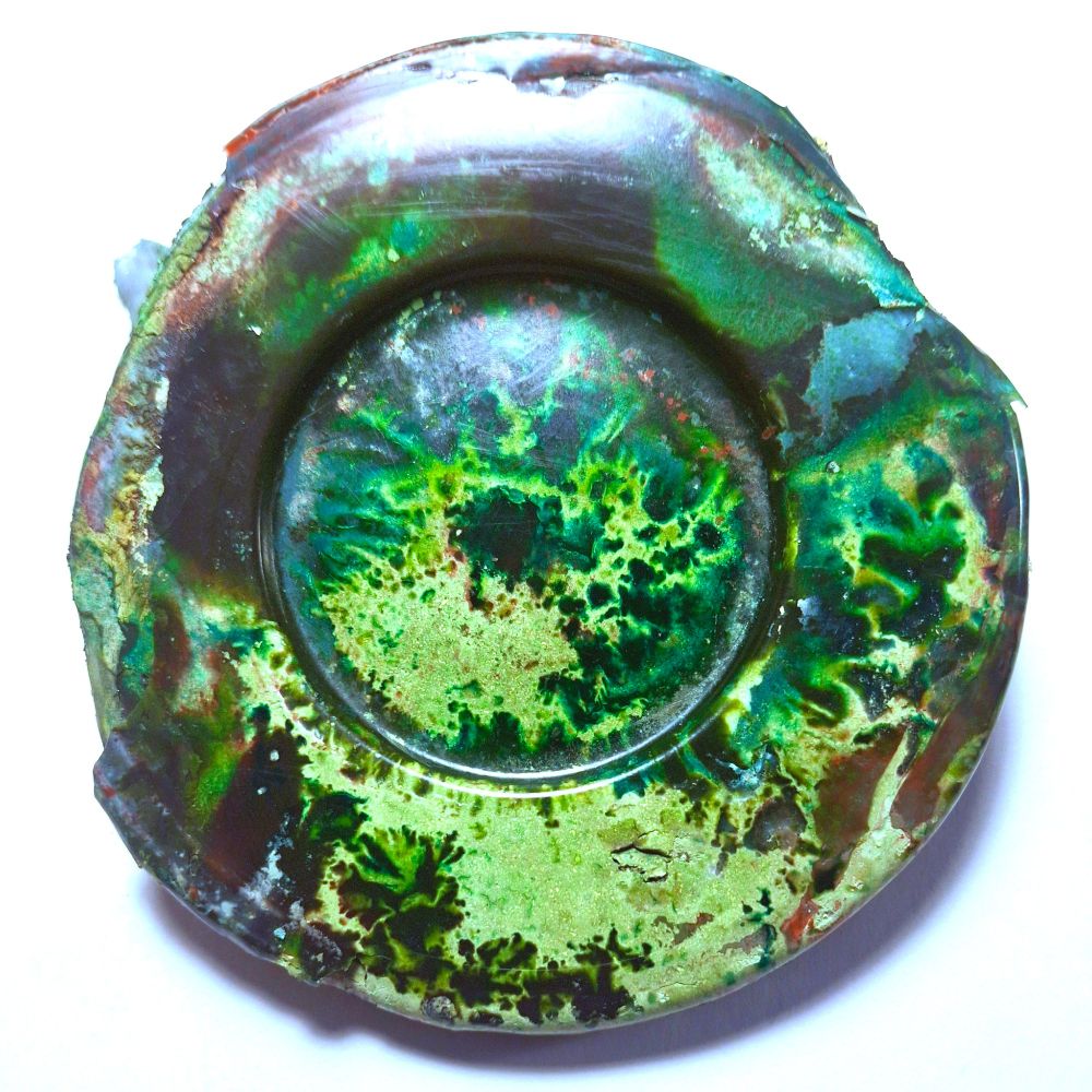 A greenish blue circle with speckles of other colors. Could be the remains of a bad experiment in governing or perhaps a lack of a spine has left a puddle of glutinous slime.