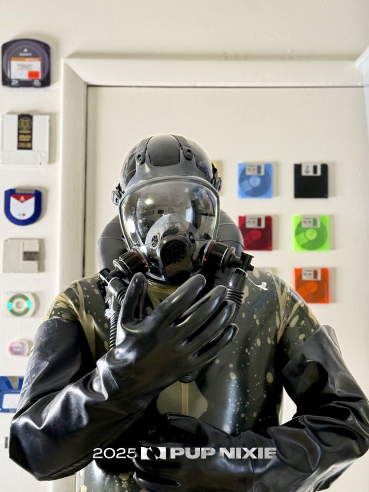 Man in rubber suit and gloves and gas mask