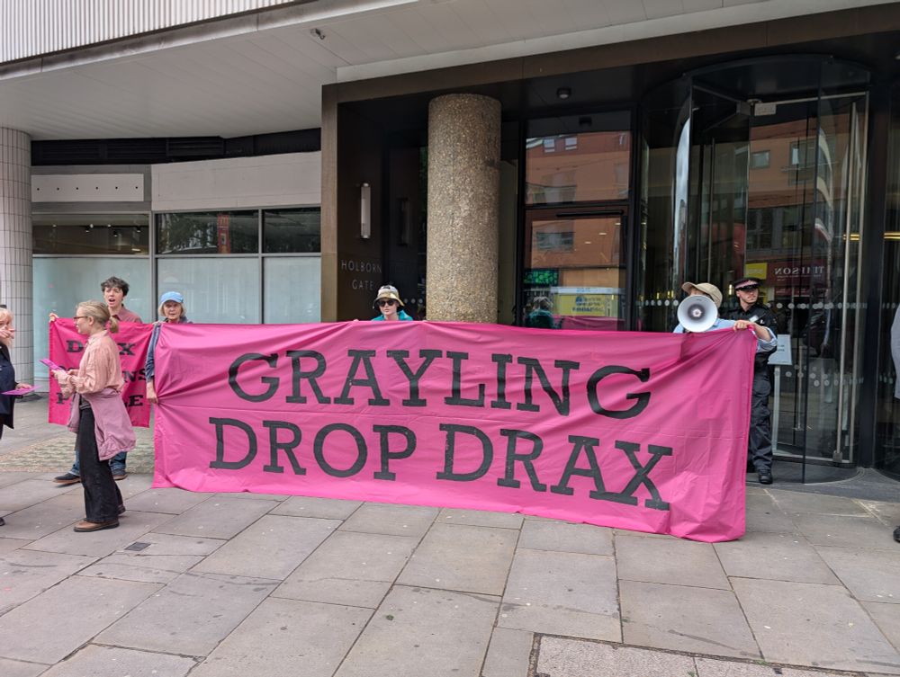 Activists from Axe Drax hold a banner outside the UK London offices of Grayling PR company, lobbyists for Drax, in London. Banner reads "Grayling Drop Drax" Photo by Axe Drax