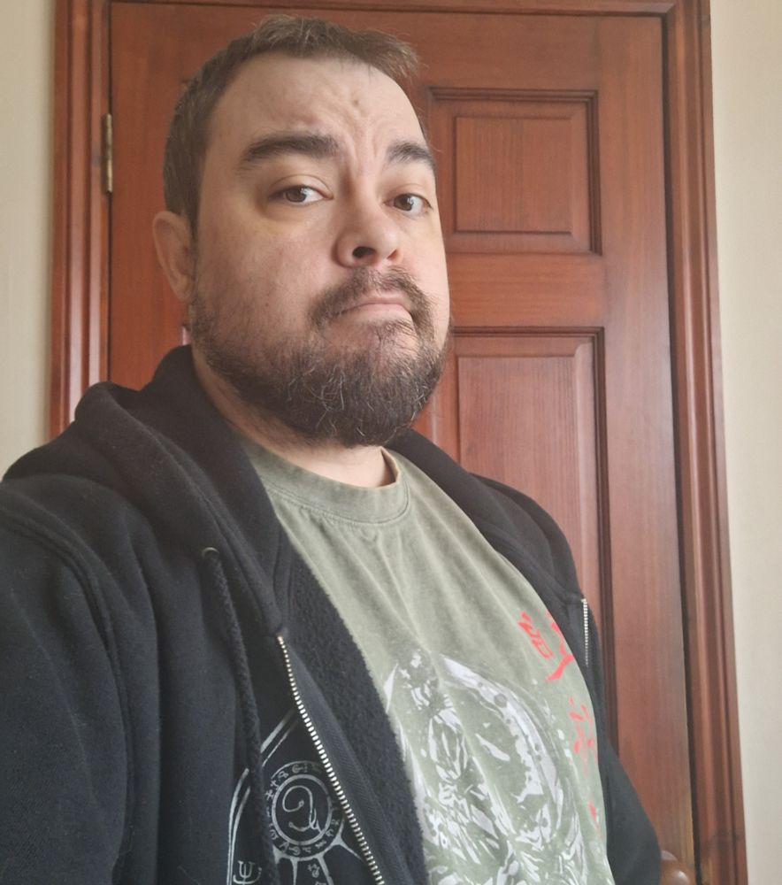 Guy in a hoodie about to get wet because the one day he's going out is the one day it rains