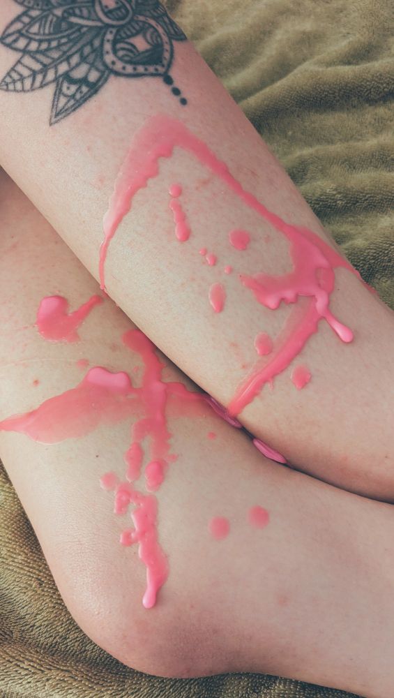 Pink wax dried on the legs of a babely bottom.  