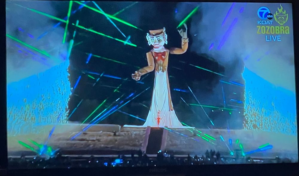 Zozobra on TV with lasers