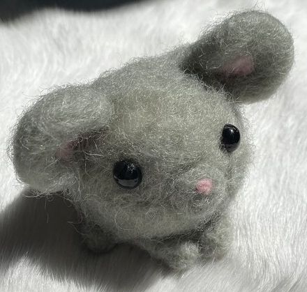 a tiny round felt mouse