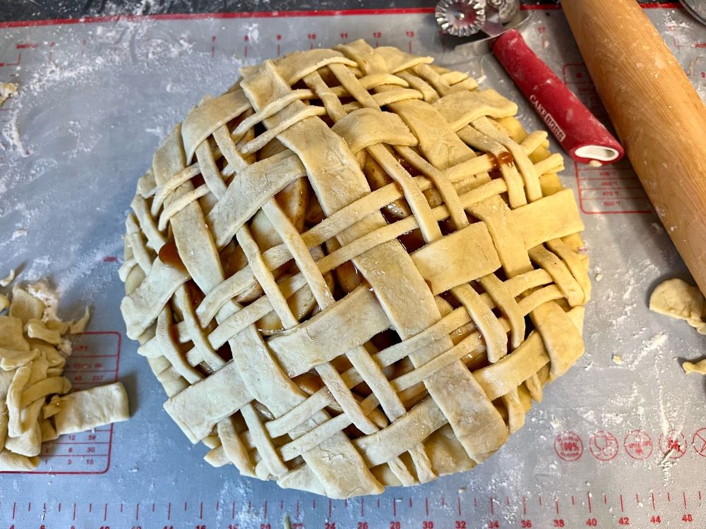 An intricate lattice top on an apple pie