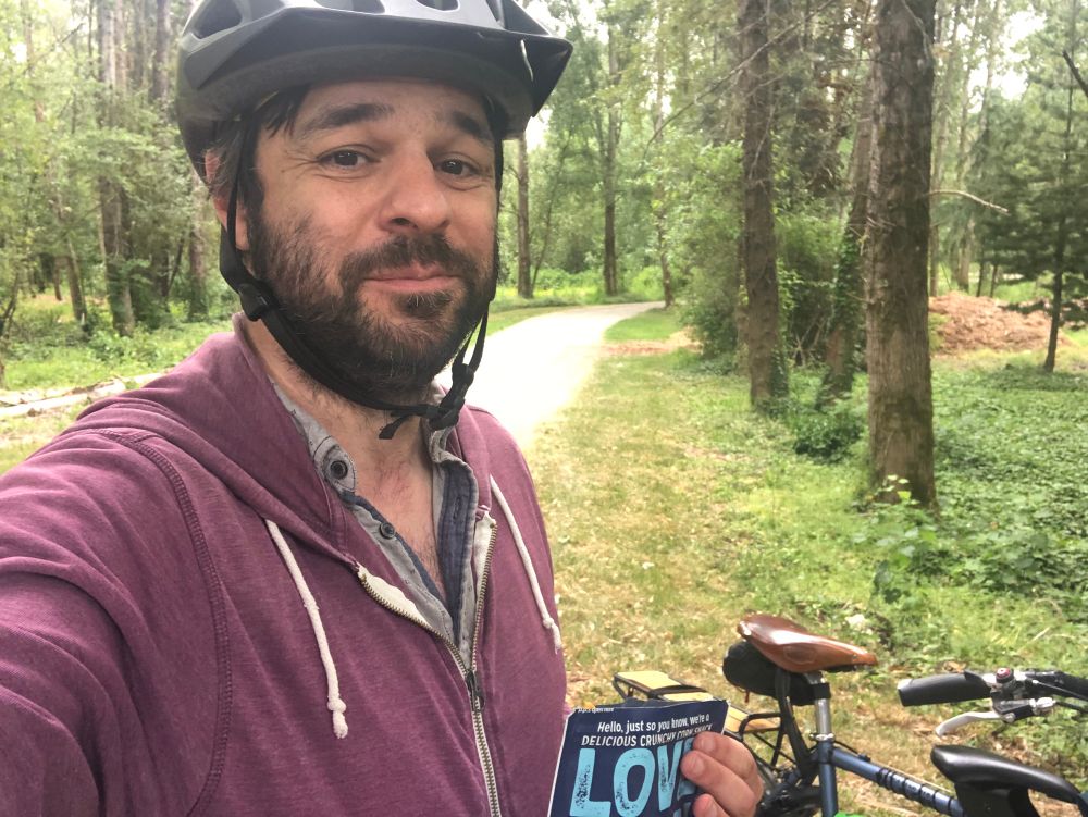 Selfie of the author in the woods next to a gravel path. 