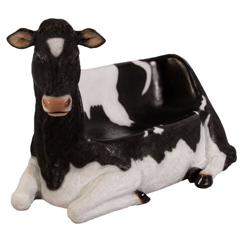 a two seater sofa in the form of a giant black and white resin dairy cow