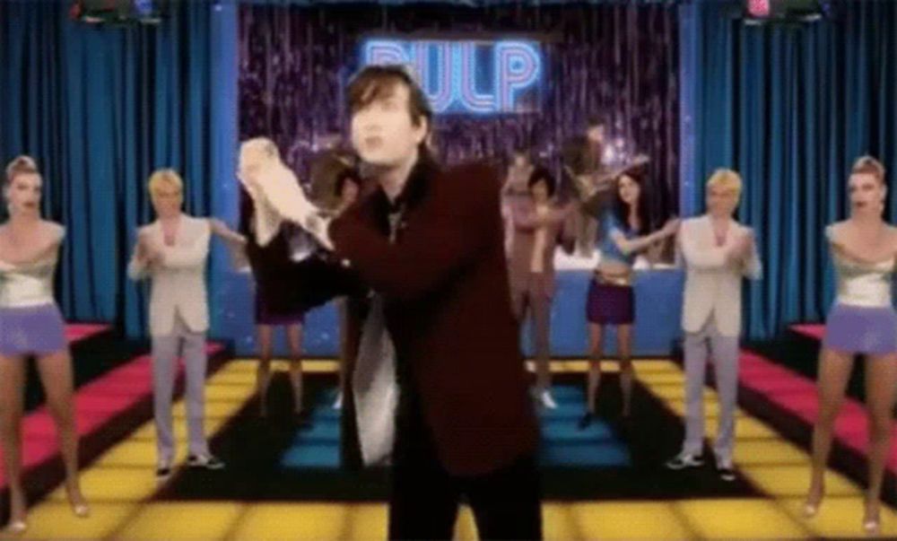 a group of people are dancing on a stage with the word pulp in the background