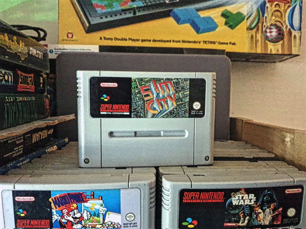 An image of the game cart for Sim City on the Snes
