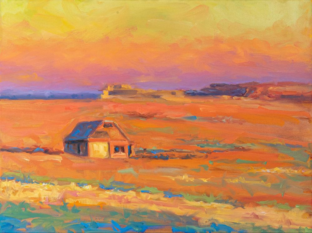 Oil painting of a Southwestern desert landscape. A stretch of open land glows under low evening light, with distant mountains and soft clouds above. Painted in an impressionist style with bold brushwork and warm, vibrant tones