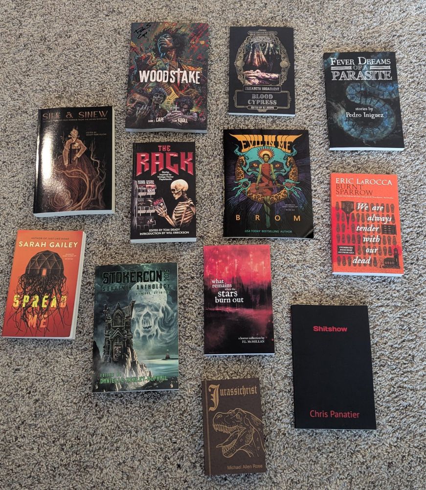 Books in a diamond shape: Woodstake, Blood Cypress, Silk and Sinew, The Rack, Evil in Me, Burnt Sparrow, Spread Me, Stokercon, What Remains When the Stars Burn Out, Shitshow, and Jurassichrist 