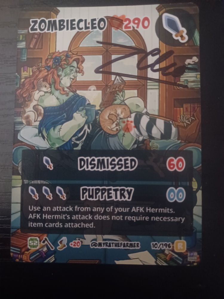 Rare signed Zombiecleo card from the Hermitcraft trading card game. There is a pink paw print and heart added in addition to the signature.