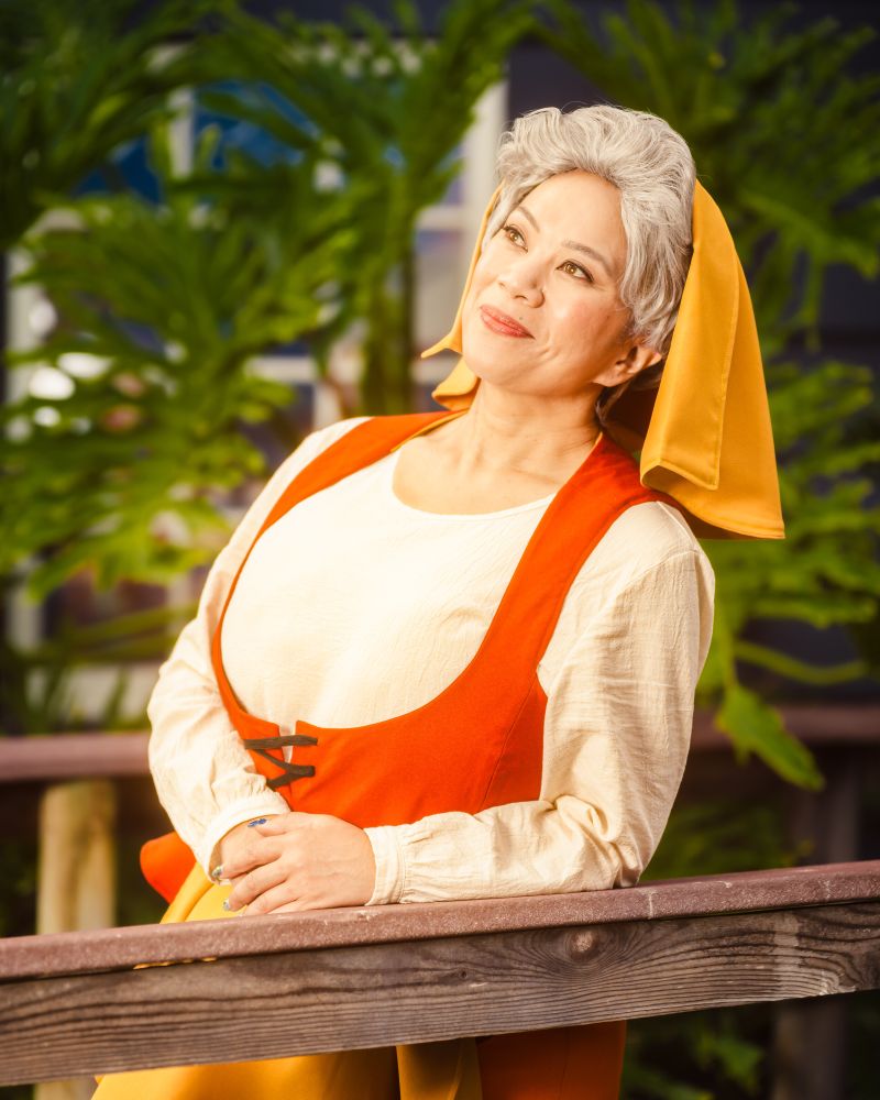 Cosplayer dressed as the incognito/peasant version of the Good Fairy Flora from Disney's Sleeping Beauty.