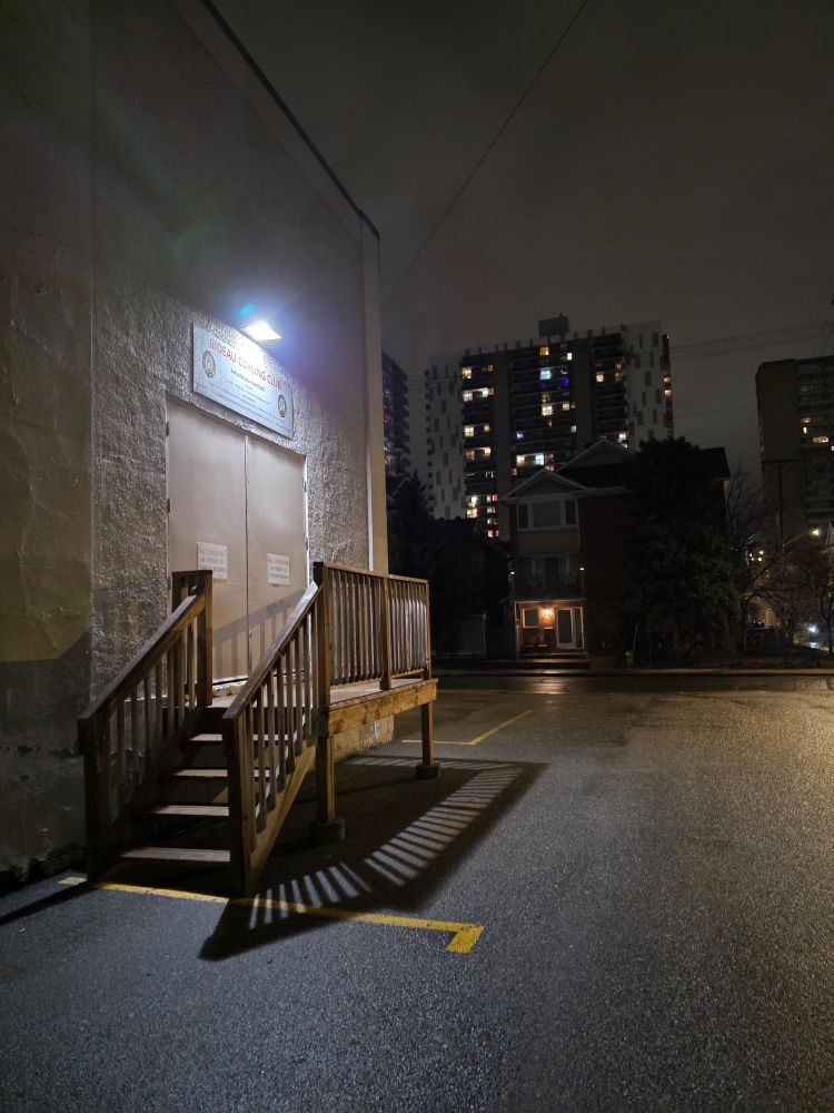 The corner of a curling rink photographed at night.