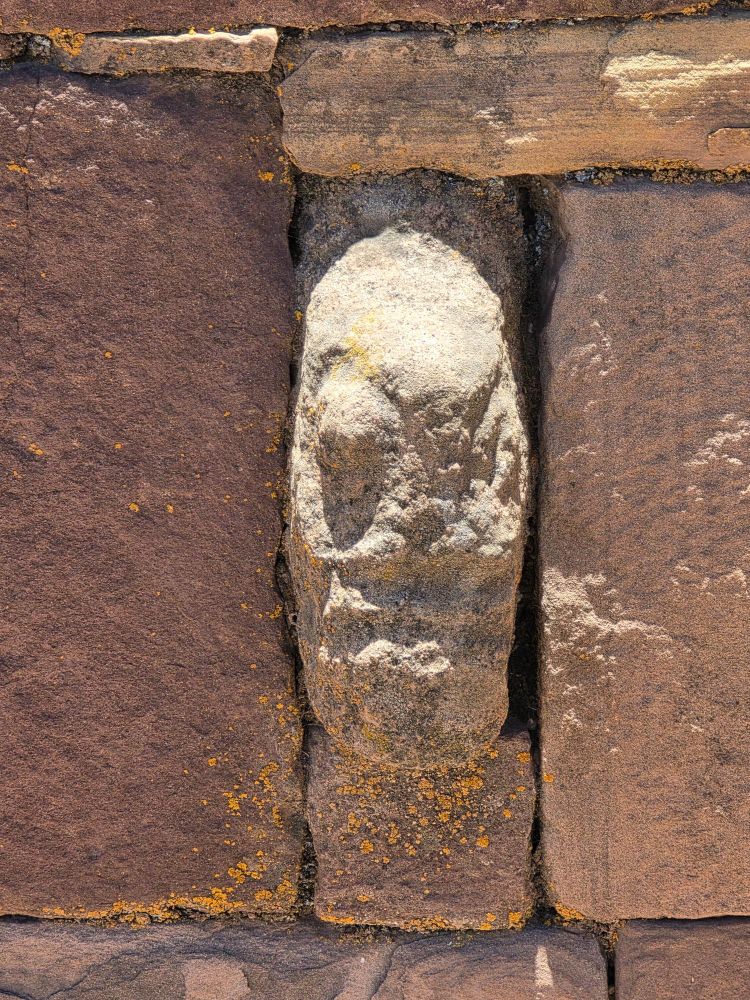 Weird narrow fish head man stone. 