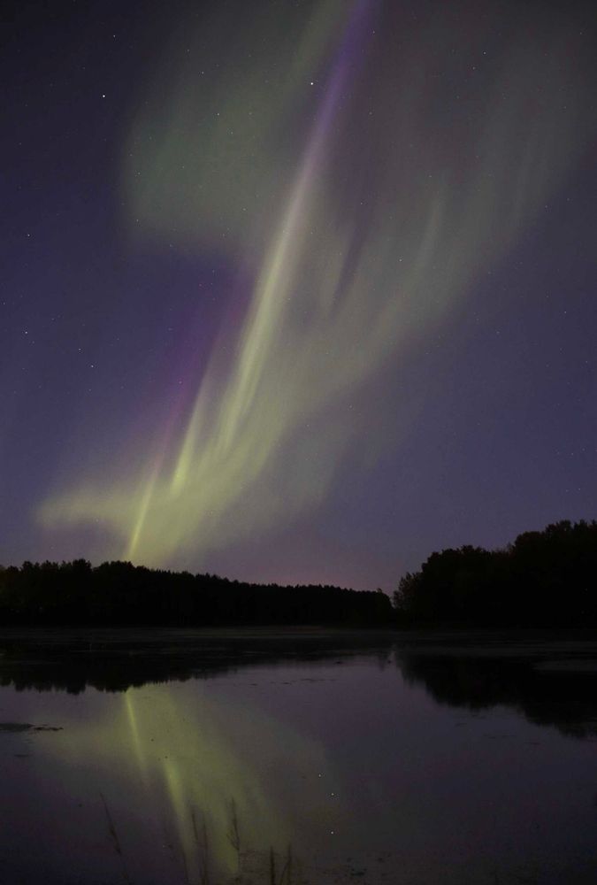 northern lights reflecting from a lake