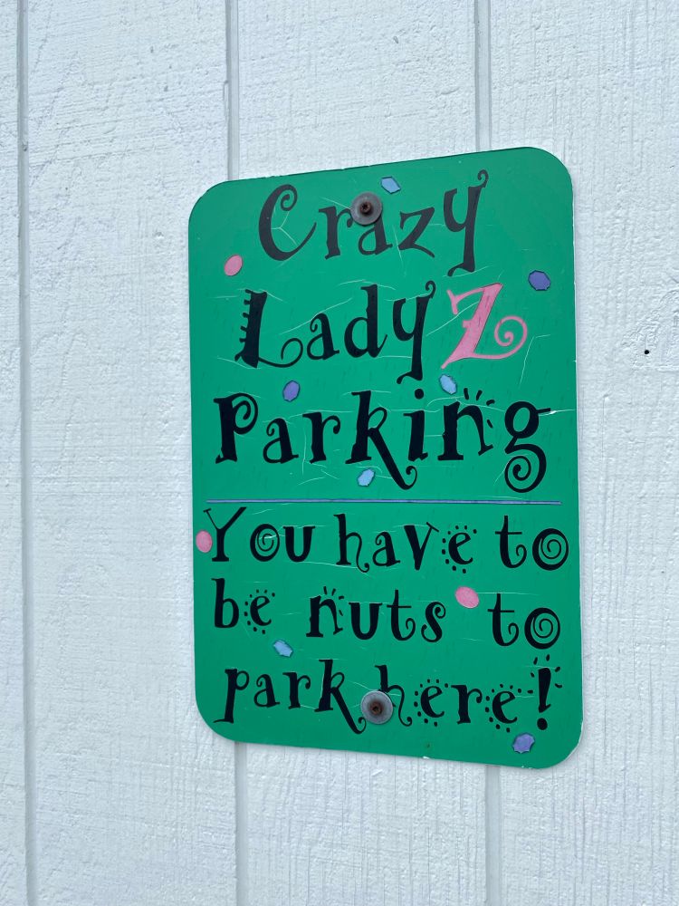 Parking lot sign that says “you have to be nuts to park here” 