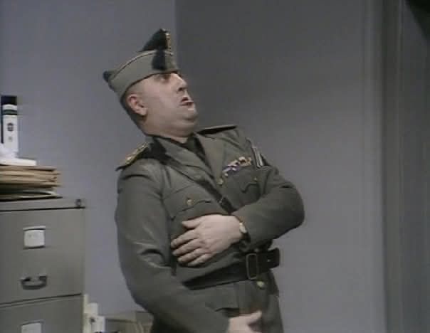 Alexei Sayle posing as Benito Mussolini in the Young Ones 