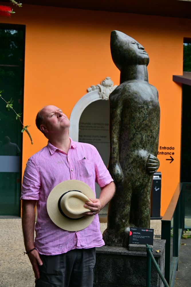 A photo of me posing next to a statue in Monte Palace Gardens, Madeira