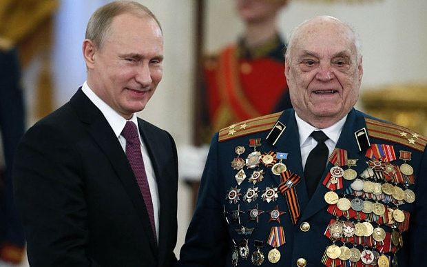 Photo of Vladimir Putin pinning another medal on heavily-bemedalled chest of Valentin Gavrilov