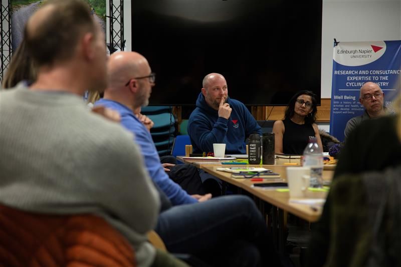 A group of people sitting around a meeting room table.