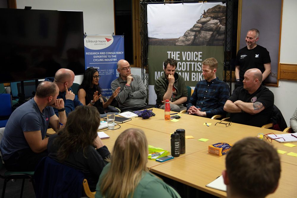 A group of people sitting around a meeting room table.