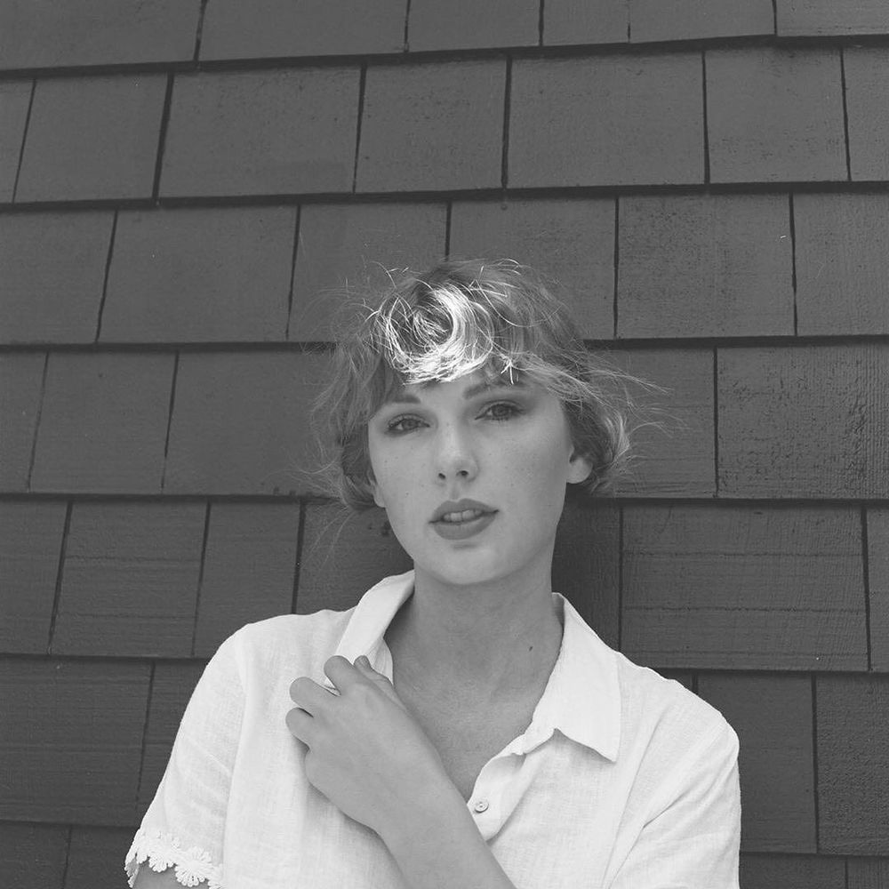 Taylor Swift from the folklore era & she is wearing a white shirt