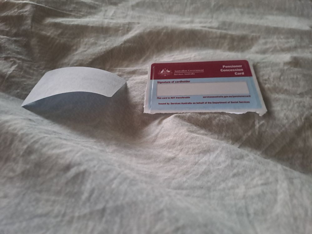 Paper concession card in two piececs as front peeled off back on receipt.